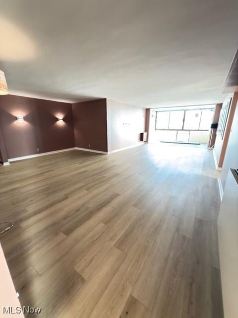 unfurnished living room with hardwood / wood-style flooring