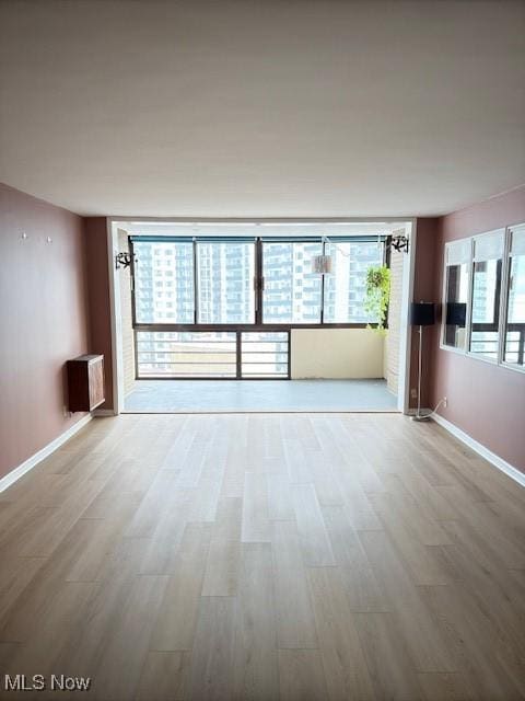 empty room with hardwood / wood-style floors