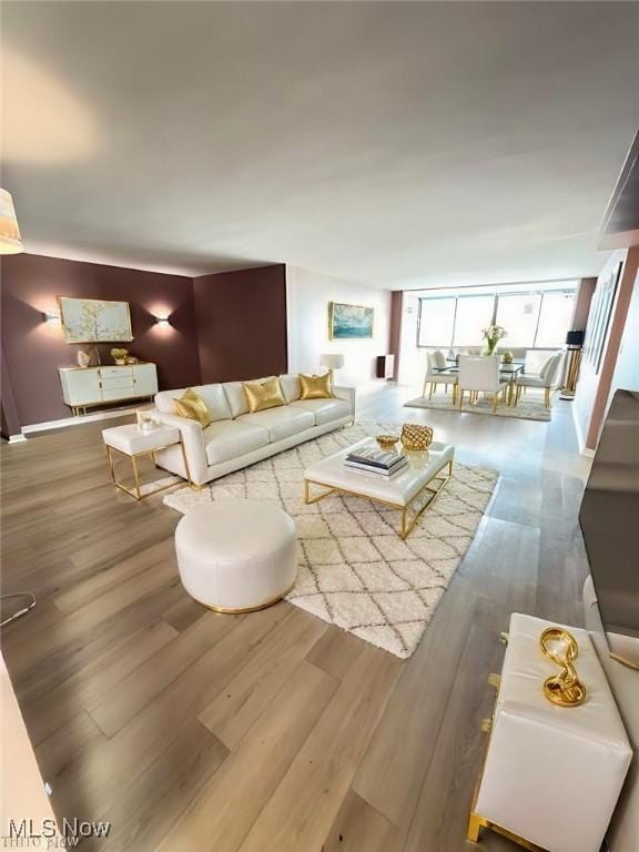 living room featuring wood finished floors and floor to ceiling windows