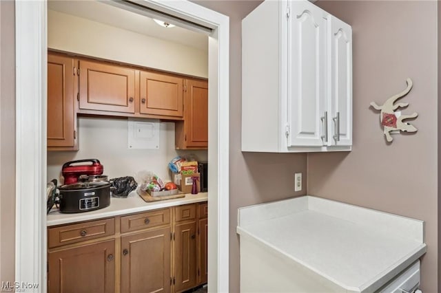 kitchen featuring brown cabinets and light countertops