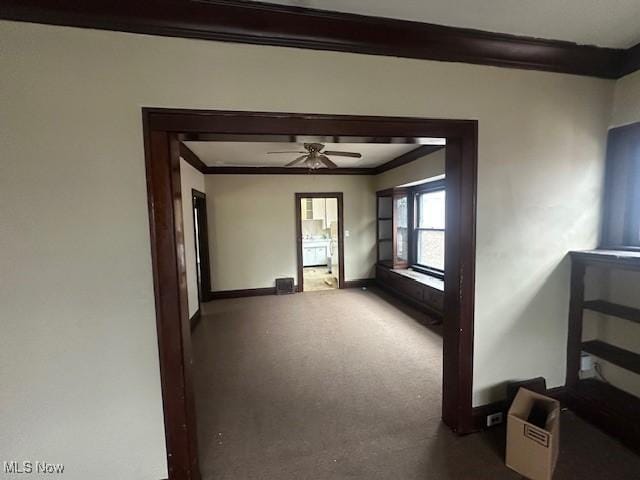 carpeted spare room featuring ornamental molding and ceiling fan