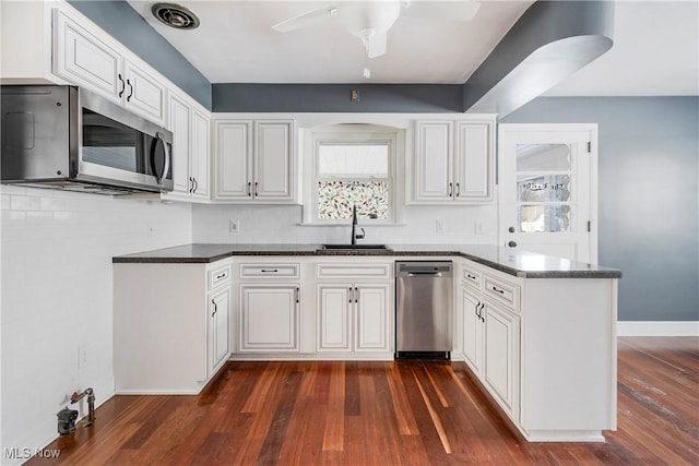 kitchen featuring ceiling fan, dark hardwood / wood-style floors, sink, white cabinetry, and appliances with stainless steel finishes