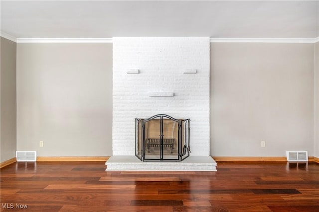 unfurnished living room featuring dark hardwood / wood-style flooring, crown molding, and a fireplace