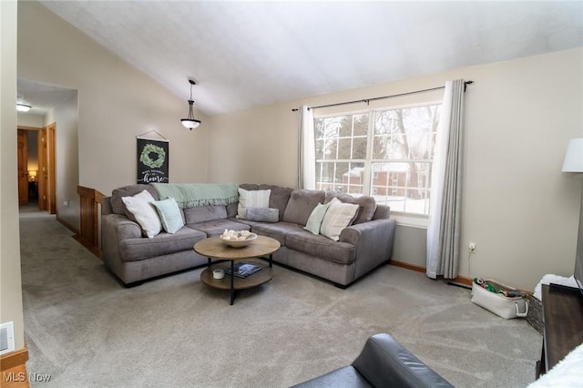 carpeted living room featuring lofted ceiling