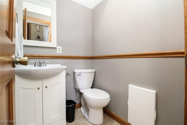 bathroom featuring toilet, vanity, and tile patterned floors