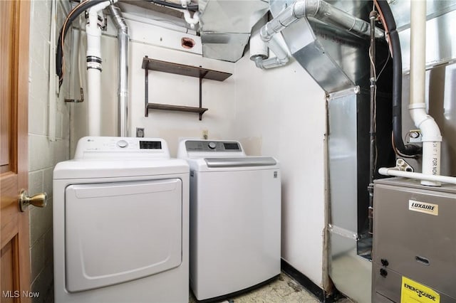 clothes washing area with separate washer and dryer