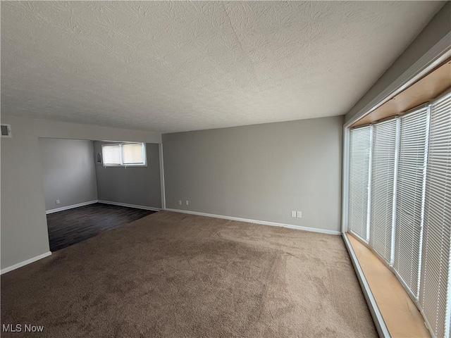 unfurnished bedroom featuring carpet floors and a textured ceiling