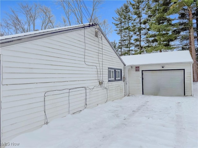 view of snow covered exterior featuring a garage