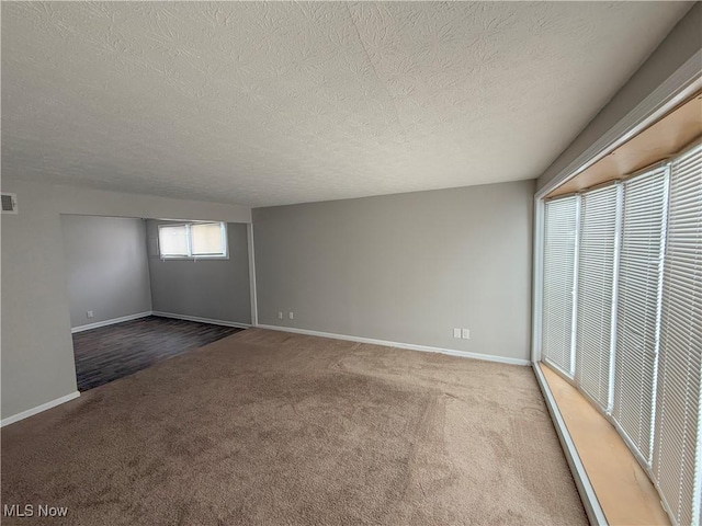 unfurnished bedroom featuring a textured ceiling and carpet flooring