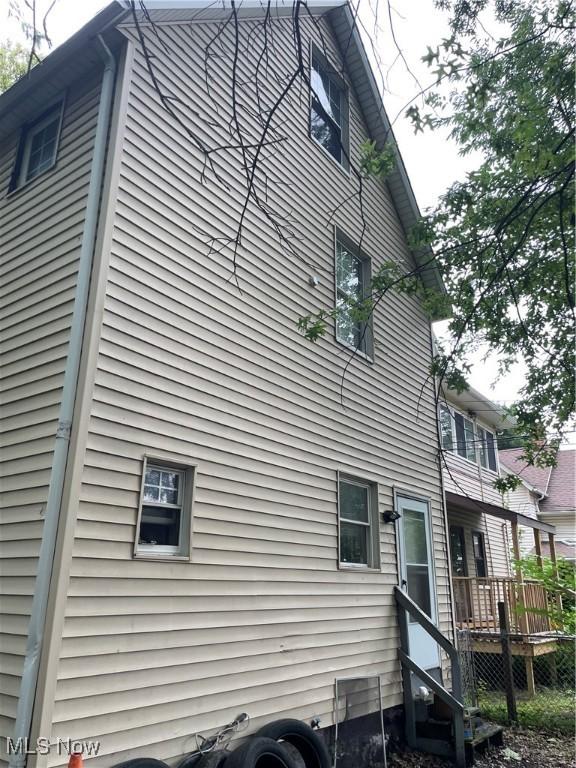 view of side of home with a wooden deck