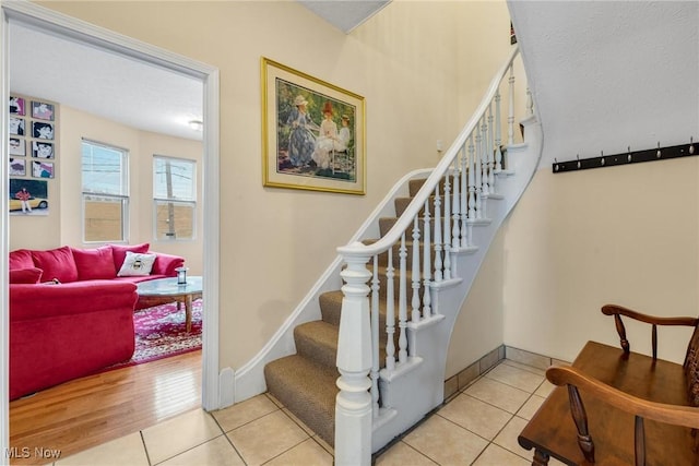 stairs featuring tile patterned flooring