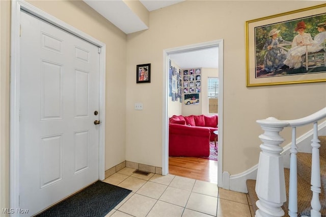 foyer entrance with light tile patterned floors