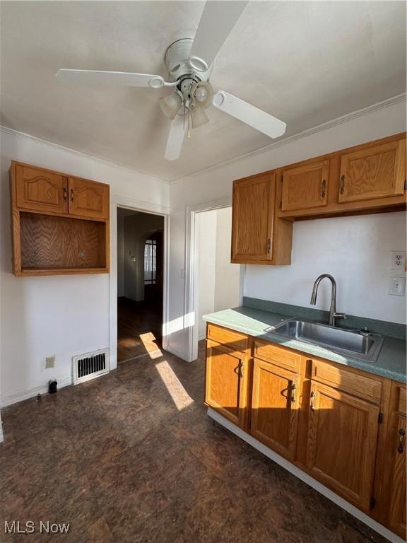 kitchen featuring ceiling fan and sink