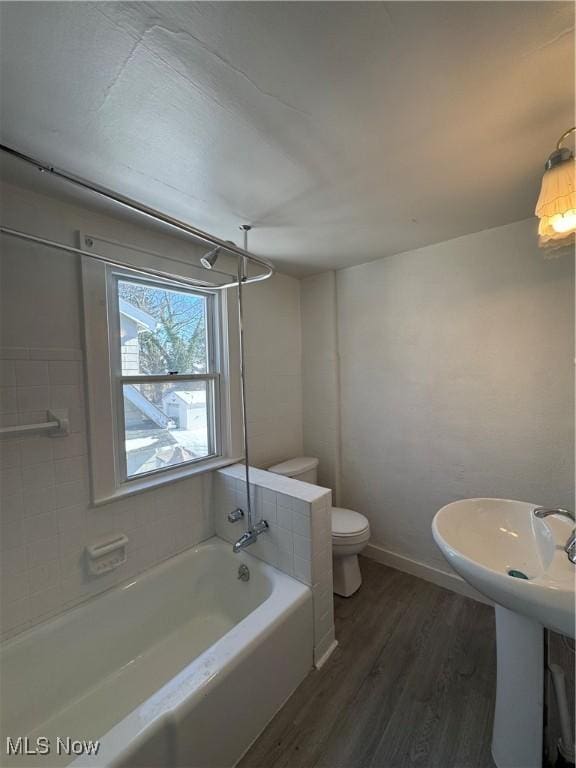 bathroom featuring toilet, wood-type flooring, and sink