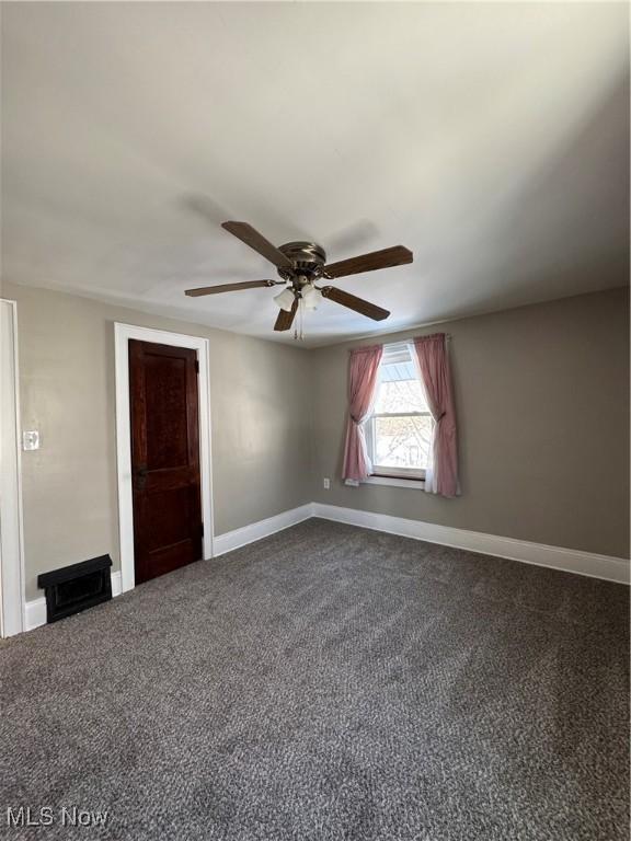 unfurnished room featuring ceiling fan and carpet floors