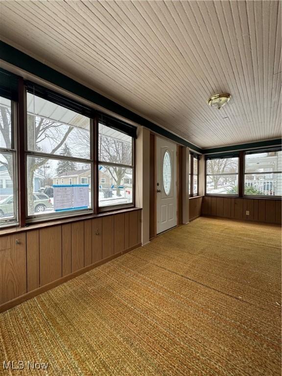 unfurnished sunroom with wooden ceiling