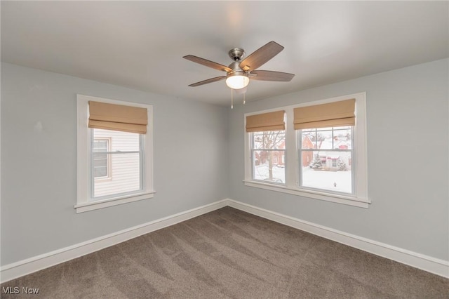 carpeted spare room with ceiling fan