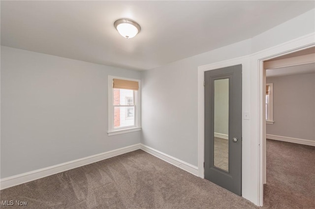 unfurnished room featuring carpet floors