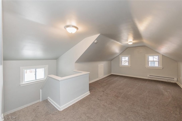 bonus room with a baseboard heating unit, carpet flooring, and vaulted ceiling