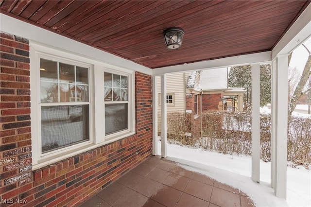 unfurnished sunroom featuring wood ceiling