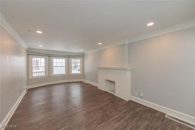 unfurnished living room with a brick fireplace, dark wood-type flooring, and ornamental molding