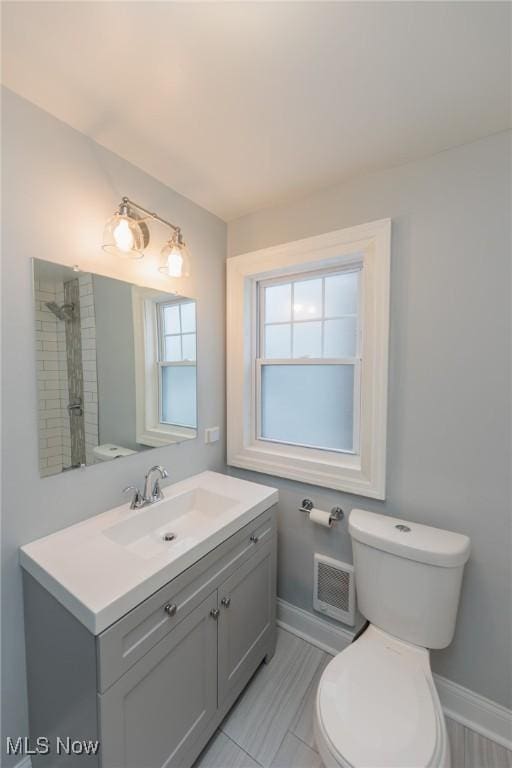 bathroom with toilet and vanity