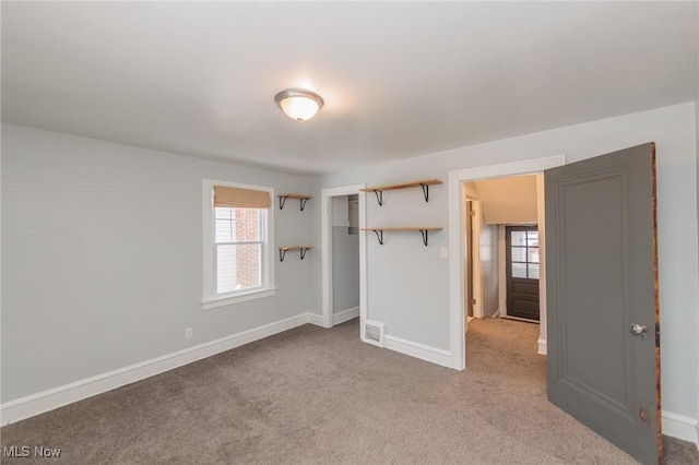 unfurnished bedroom with light colored carpet