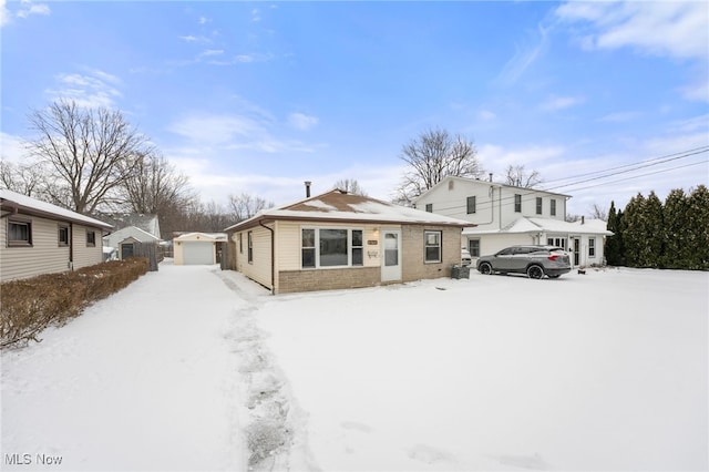 view of front of property with a garage and an outbuilding