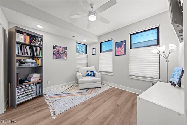 living area featuring ceiling fan and wood-type flooring