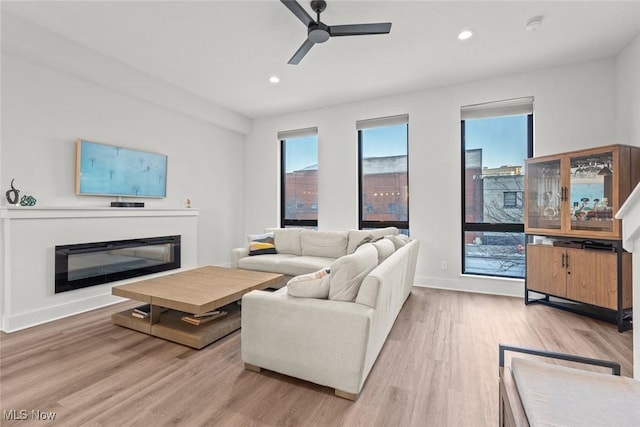 living room with ceiling fan and hardwood / wood-style floors