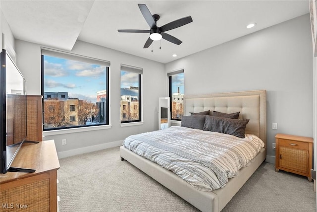 bedroom featuring light colored carpet and ceiling fan