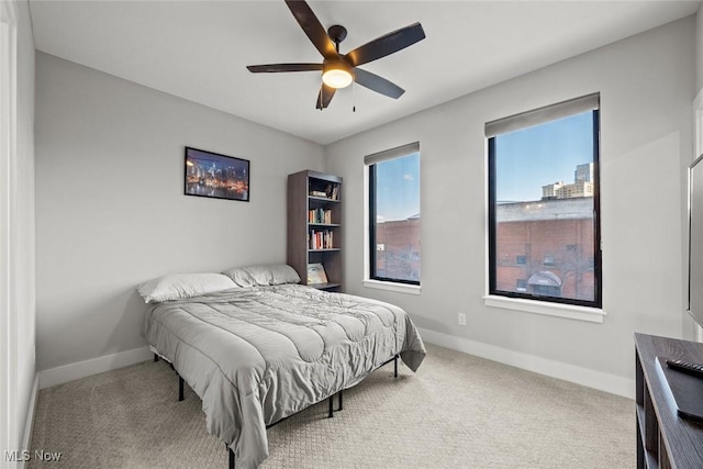 bedroom featuring ceiling fan and carpet