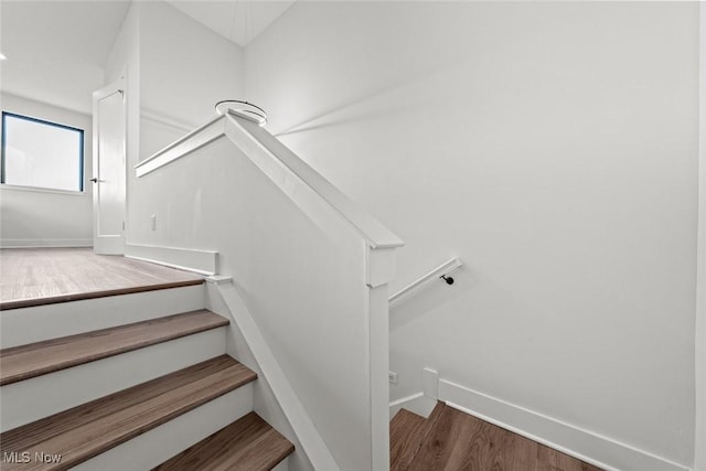 stairs featuring hardwood / wood-style floors