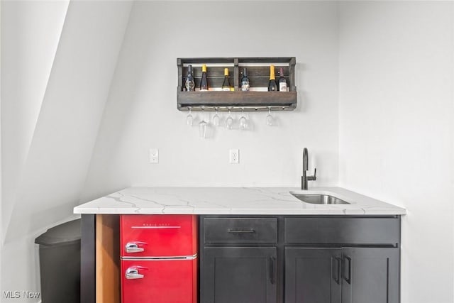 bar with sink and light stone countertops