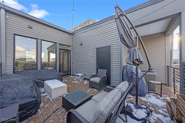 view of patio featuring a wooden deck, an outdoor living space, and a grill