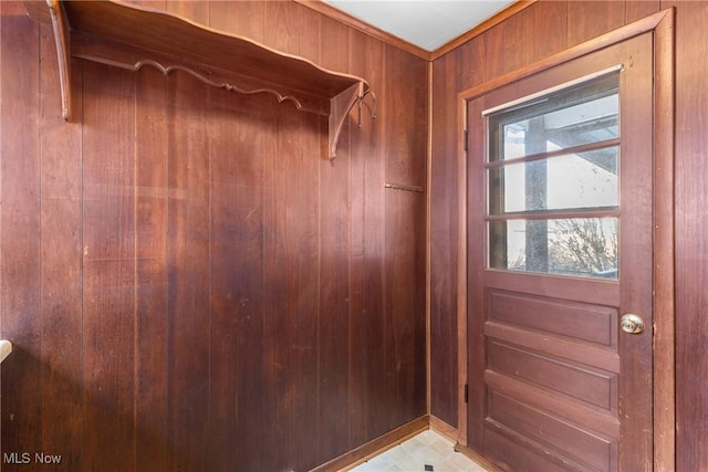 doorway with wood walls