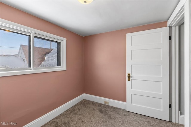 spare room featuring light colored carpet