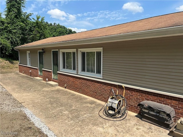 view of side of home featuring a patio