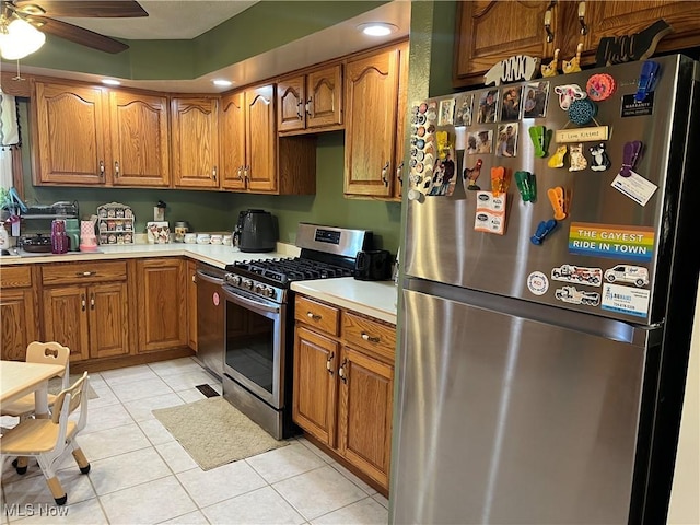 kitchen featuring ceiling fan, light tile patterned floors, and appliances with stainless steel finishes