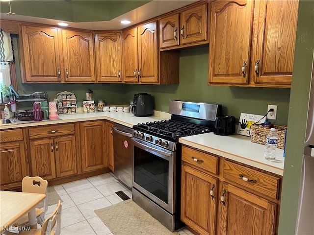 kitchen featuring light tile patterned floors and appliances with stainless steel finishes