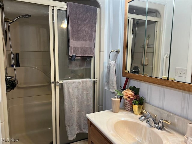 bathroom featuring vanity and a shower