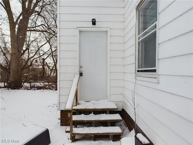 view of snow covered property entrance