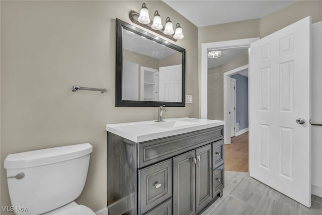 bathroom featuring toilet and vanity