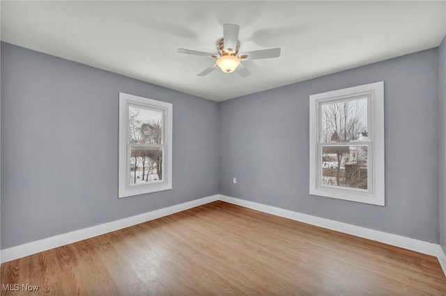 empty room featuring ceiling fan and light hardwood / wood-style flooring