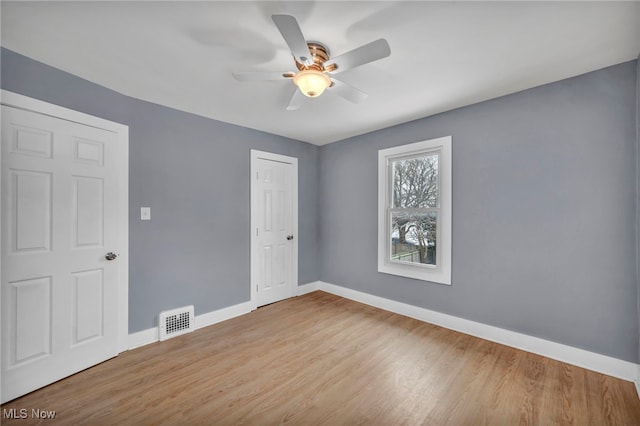 empty room featuring ceiling fan and light hardwood / wood-style flooring