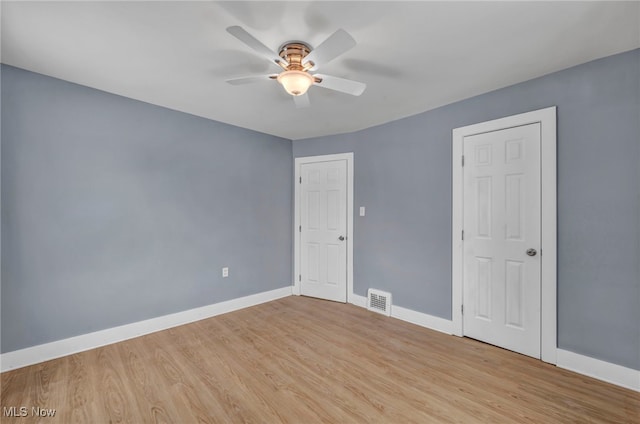 unfurnished room with ceiling fan and light hardwood / wood-style floors