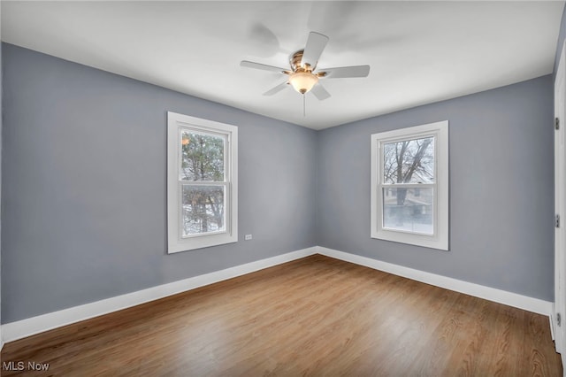 empty room featuring ceiling fan and hardwood / wood-style floors