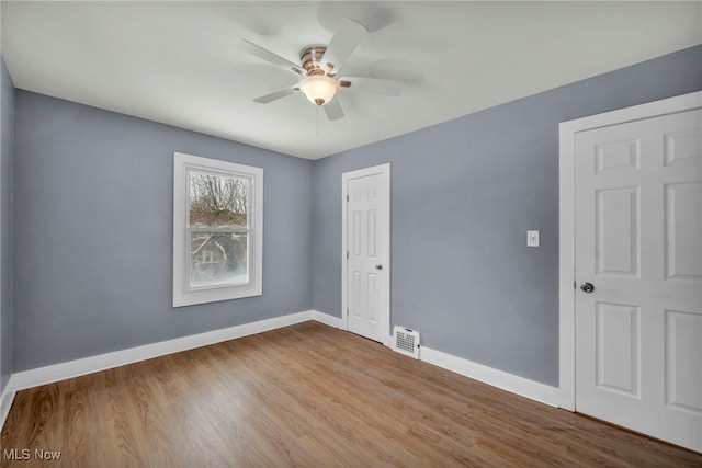 spare room featuring ceiling fan and light hardwood / wood-style flooring