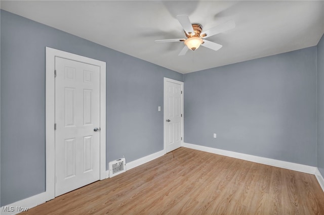 spare room with ceiling fan and light hardwood / wood-style flooring