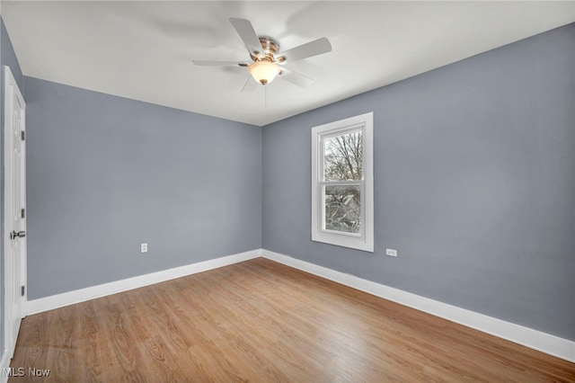 empty room with ceiling fan and light wood-type flooring